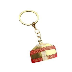 Traditional yurt shape alloy keychain in gold finish with red and white enamel details