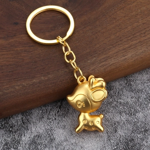 Creative 3D golden reindeer keychain with lucky charm aesthetic on a rustic wood base