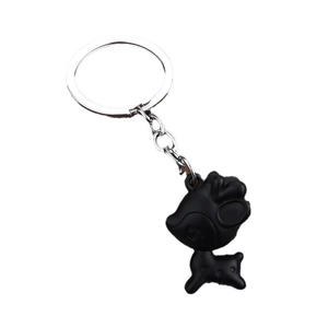 Creative black deer figurine keychain with silver metal ring on a white background