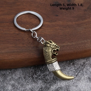 Retro dragon head keychain in bronze zinc alloy on dark wood tray, size 5x1.8cm 9g