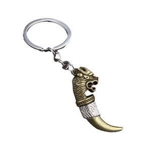 Vintage bronze wolf head pendant keychain with crescent tooth and engraved details