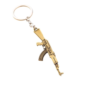 Bronze AK-47 alloy weapon model keychain with detailed rifle structure on white background