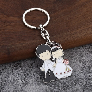 Détail d'un porte-clés émaillé pour mariés avec figurines de mariage en métal créatif
