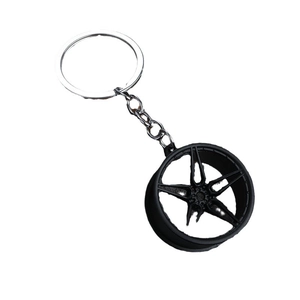 Metallic five-spoke black car wheel rim keychain with a silver chain and metal ring