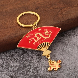 Chinese dragon fan keychain with red lacquer, gold relief, and traditional knot tassel