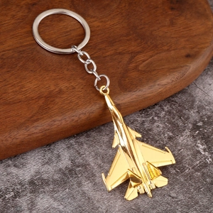 Polished gold alloy fighter jet model keychain displayed on a premium textured background