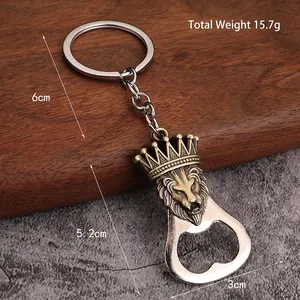Vintage lion head crown bottle opener keychain in bronze finish on wooden background