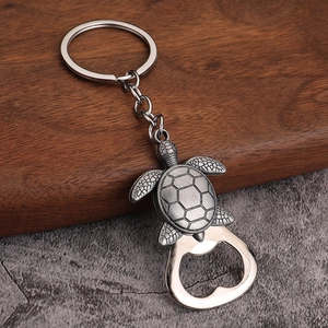 Detailed macro view of vintage silver turtle keychain with integrated bottle opener function