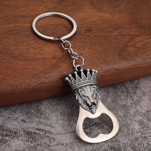 Close-up of vintage lion head bottle opener keychain with relief texture on wood surface