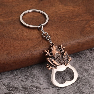 Macro detail of frog-shaped bottle opener keychain with embossed bronze texture