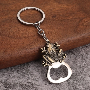 Close-up of vintage bronze frog keychain with integrated bottle opener and metal ring