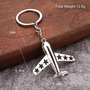 Silver metal fighter aircraft keychain weighing 12.6g with black star wing details
