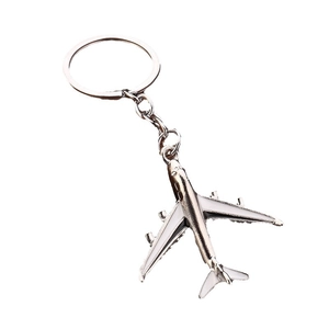 Porte-clés avion en métal argenté poli avec ailes blanches pour cadeau souvenir