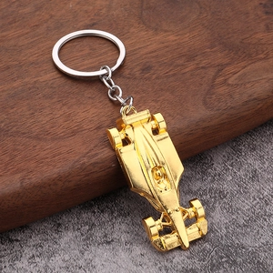Golden F1 racing car metal keychain with polished finish and sturdy silver keyring