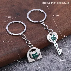 Silver four-leaf clover keychain set with heart-shaped key and lock charms for luck