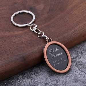 Macro detail of antique bronze oval photo frame keychain with photo insert measurements