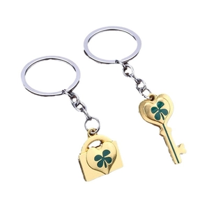 Golden heart lock and key keychain set with green four-leaf clover enamel charms