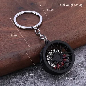 Black and silver car wheel rim keychain with red brake caliper and precise dimensions