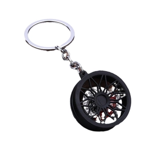 Car brake disc hub keychain with black multi-spoke wheel and red brake caliper