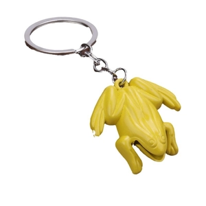 Creative bright yellow frog metal keychain with a matte finish on a clean white background