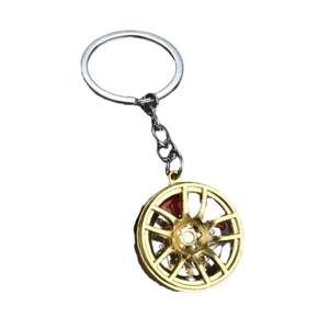 Golden alloy wheel rim keychain with red brake caliper and silver metal chain