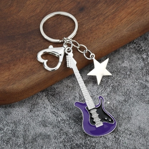 Close-up of purple guitar keychain with enamel finish and silver heart-shaped clasp