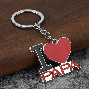 Macro shot of silver I Love PAPA heart keychain with red enamel and polished finish