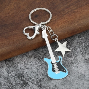 Detail of sky blue guitar keychain with star pendant and heart-shaped lobster clasp