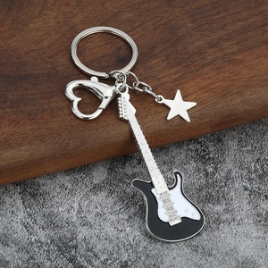 Electric guitar keychain with heart clasp and star charm on a premium wooden background