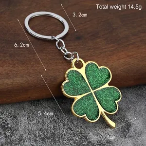 Green glitter four-leaf clover keychain with gold metal plating and total weight 14.5g