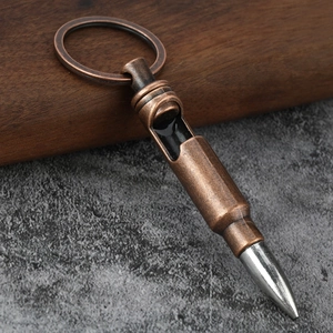 Macro detail of bullet shaped metal whistle keychain with vintage bronze finish