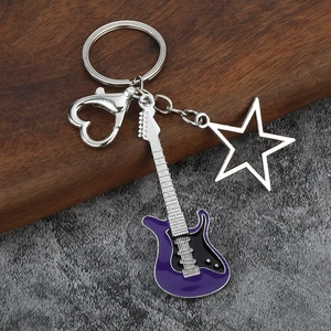 Detail of purple enamel electric guitar keychain with star charm and heart clasp