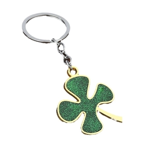 Sparkling green four-leaf clover keychain with gold edges and glittery finish