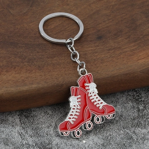 Close-up of red roller skate keychains with silver finish on a wooden stand