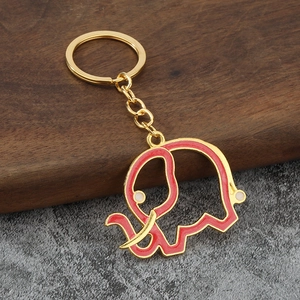 Detailed close-up of a red enamel elephant keychain with gold-plated metal alloy edges
