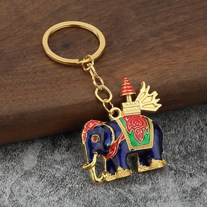 Exquisite Thai elephant keychain with blue enamel and gold plating on a stone base