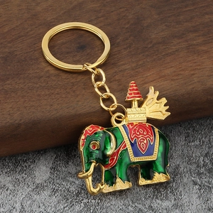 Detailed close-up of Thai elephant keychain with green enamel and gold-tone metal ring