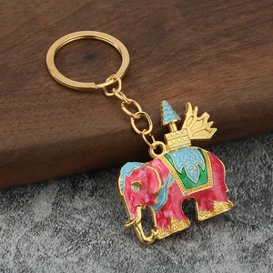 Detailed close-up of a colorful elephant keychain with pink and blue enamel on gold-tone metal