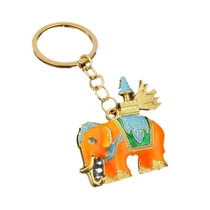 Golden Thai elephant keychain with colorful enamel coating and ornate tower ornament