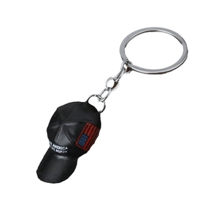 Black baseball cap keychain with US flag and Keep America Great Again slogan on white background
