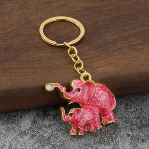 Detailed close-up of golden elephant keychain with pink marble enamel texture finish