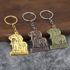 Three elephant keychains in gold, copper, and bronze with I Love Thailand engraving