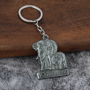 Detailed close-up of vintage zinc alloy elephant pendant with I Love Thailand relief