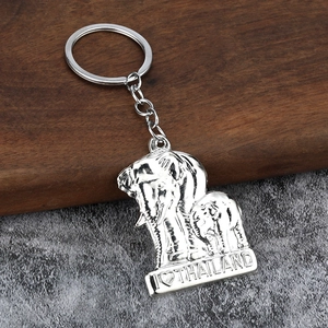 Macro shot of silver metal elephant charm with I Love Thailand text on a textured base