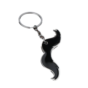 Creative mustache metal keychain with black enamel finish and silver trim in a flat lay view