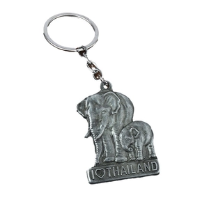 Vintage silver alloy elephant keychain with I Love Thailand engraved on white background