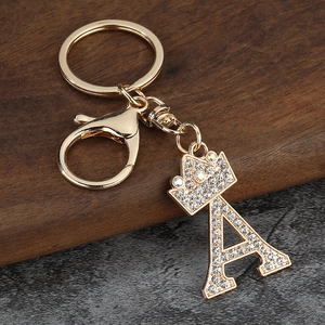 Vue macro du porte-clés lettre A dorée avec strass brillants et détail de couronne