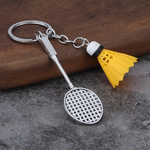 Close-up of a silver badminton racket and yellow shuttlecock sports keychain charm