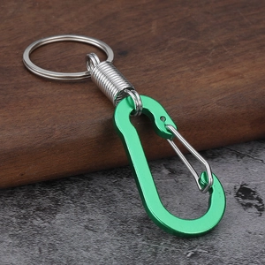 Detail of green carabiner keychain with spring mechanism and stainless steel split ring