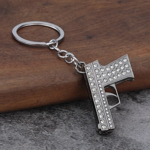 Hip hop style pistol keychain with sparkling rhinestones in dark grey alloy finish